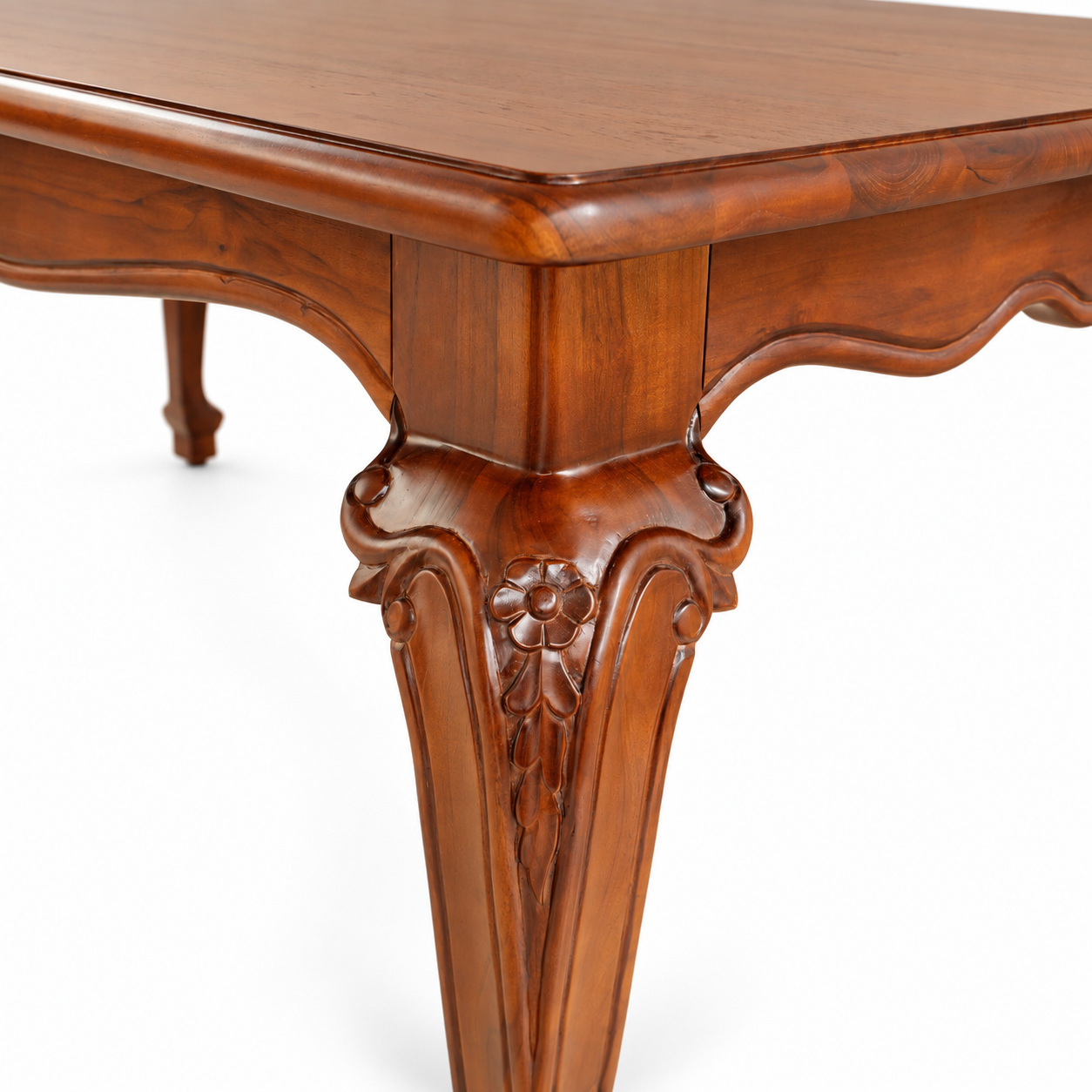 Close-up of Louis Dining Table No.5, showing carving on a walnut-finished table leg and the curved apron.