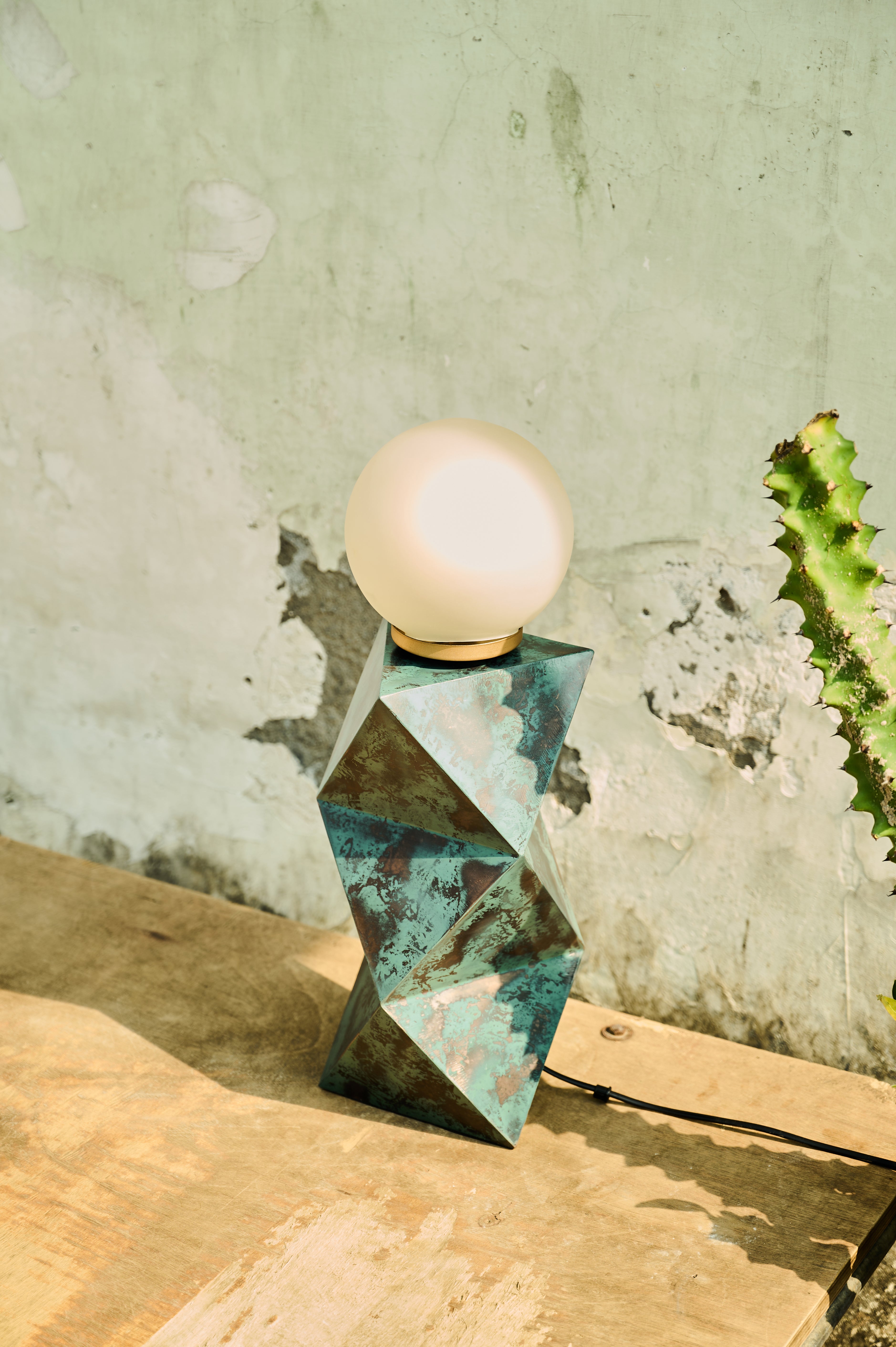 Facet Table Lamp angled view beside a textured wall