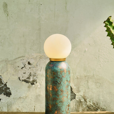 Moon Table Lamp with a globe shade on a wooden surface
