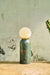 Moon Table Lamp with a globe shade on a wooden surface