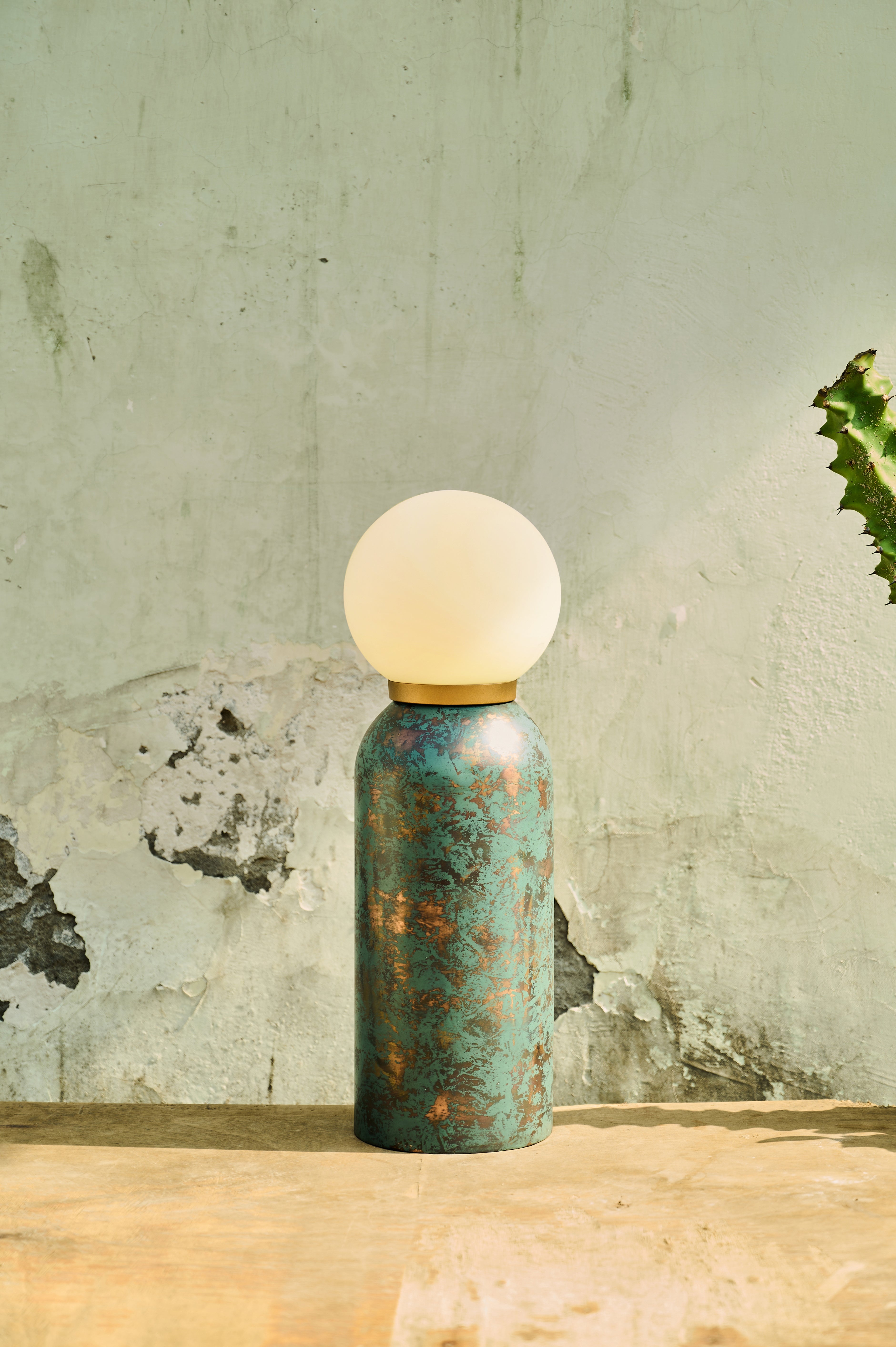 Moon Table Lamp with a globe shade on a wooden surface