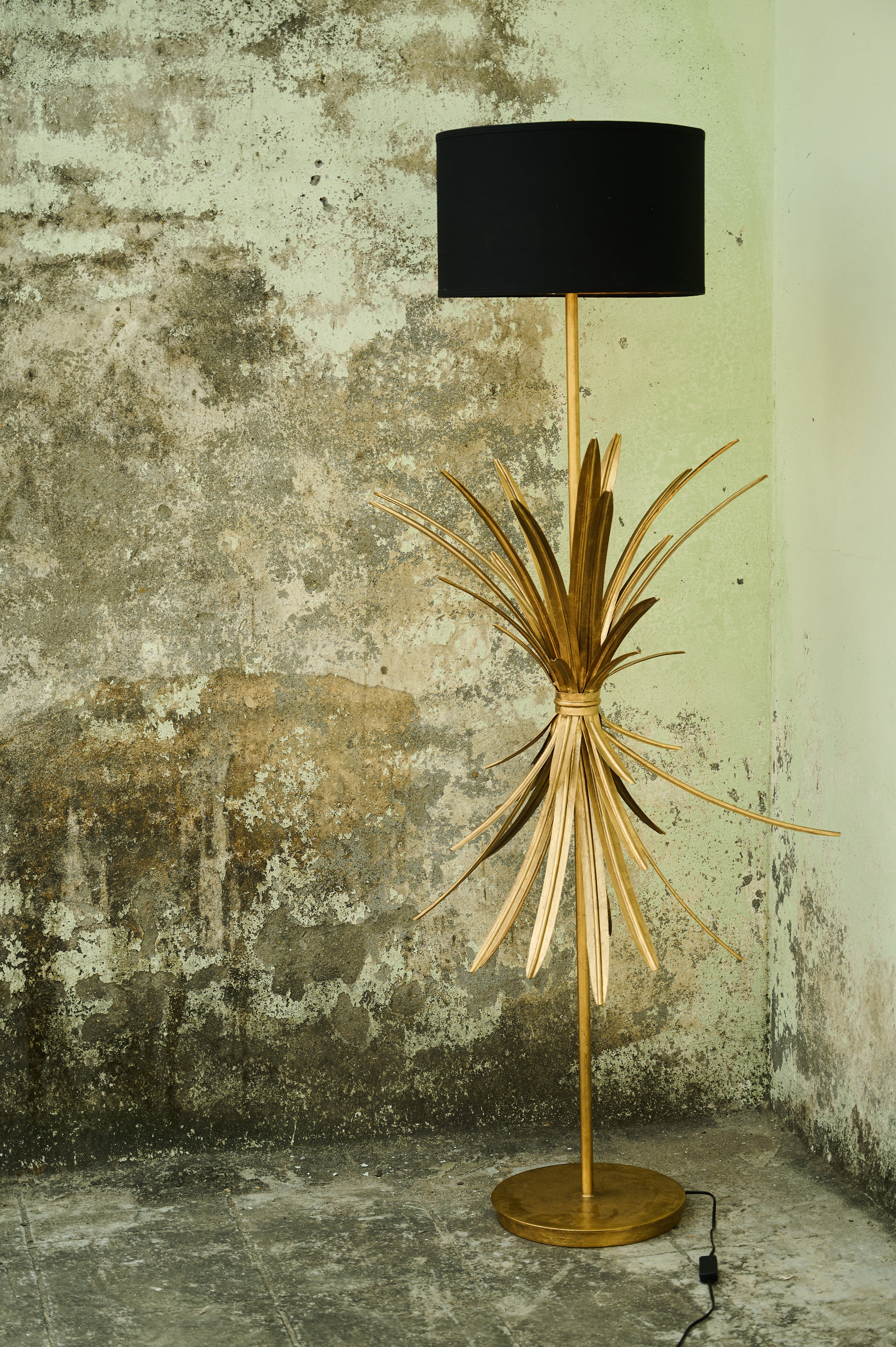 Palmette Floor Lamp full view beside a textured wall