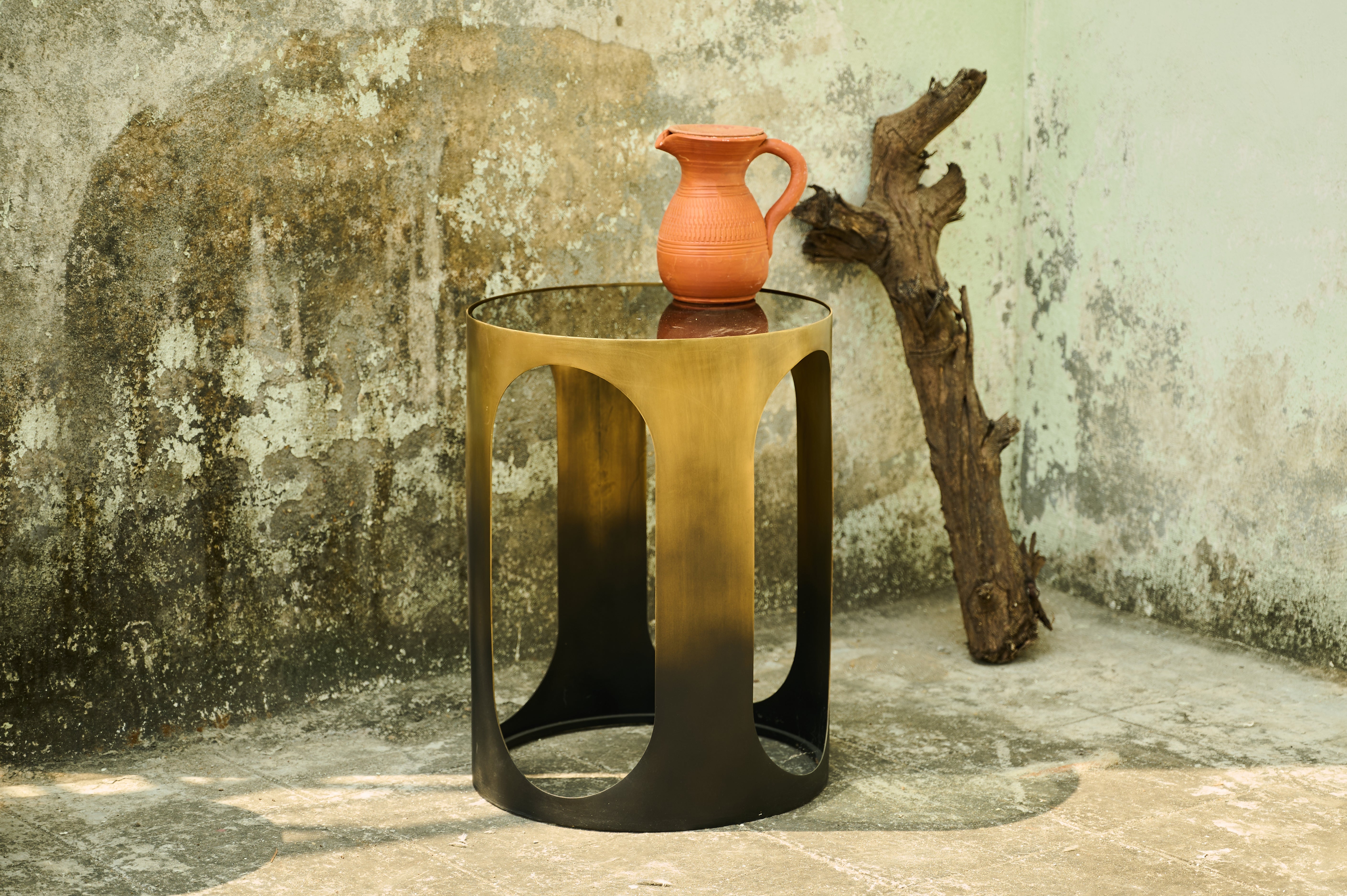 Oval Side Table wide view beside a textured wall