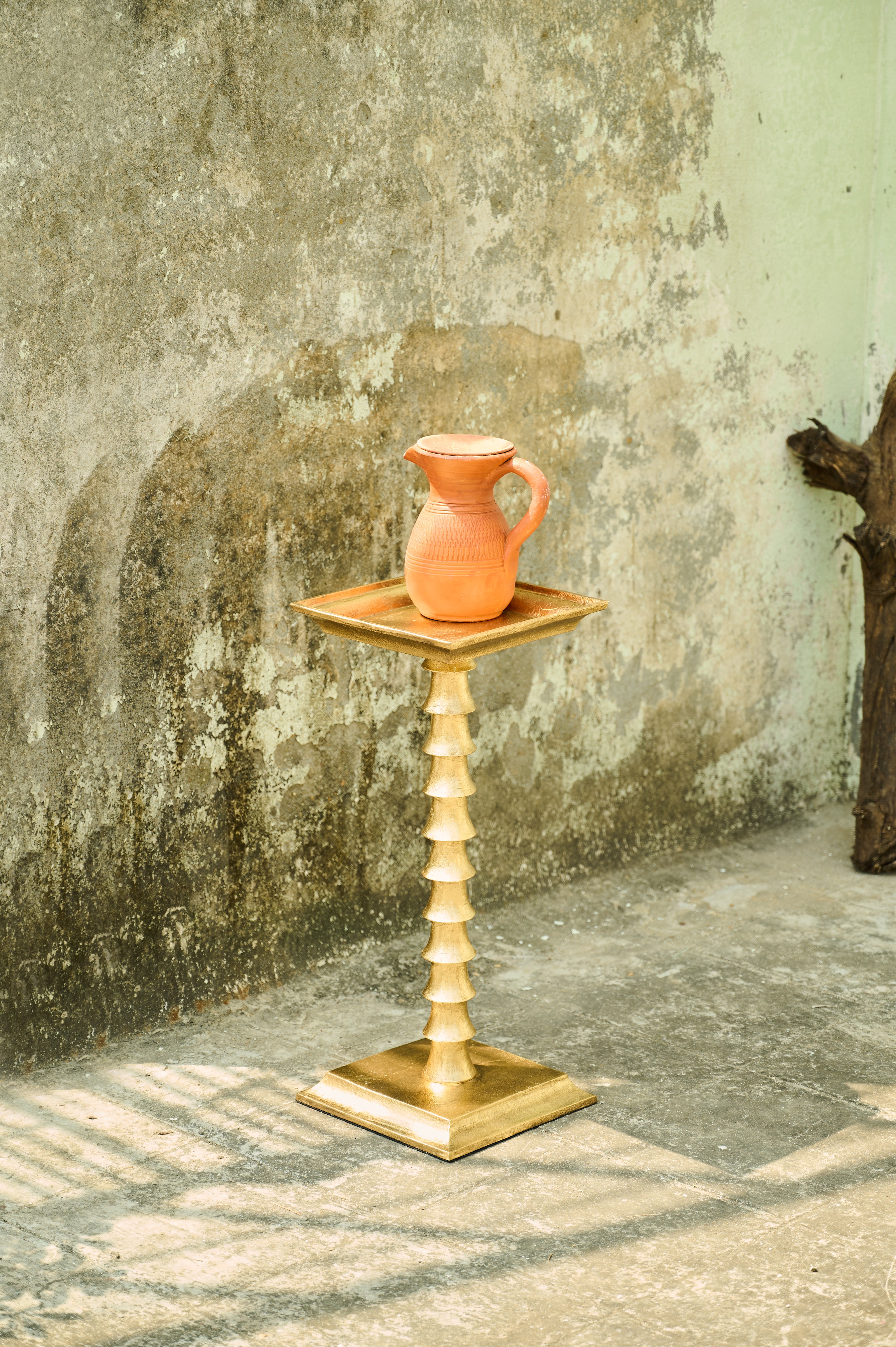Trunk Drink Table full view beside a textured wall