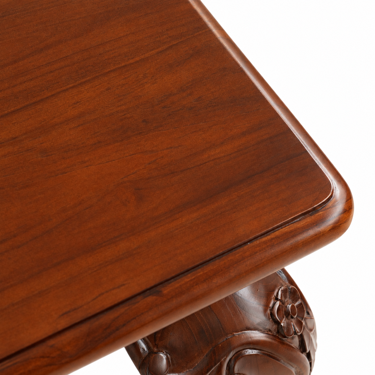 Close-up of Louis Dining Table No.5, showing the wood grain and shaped edge of its walnut-finished top.