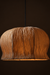 Papyrus Bellflower Pendant Lamp illuminated, showing its rounded crown and folded shade against a dark background.