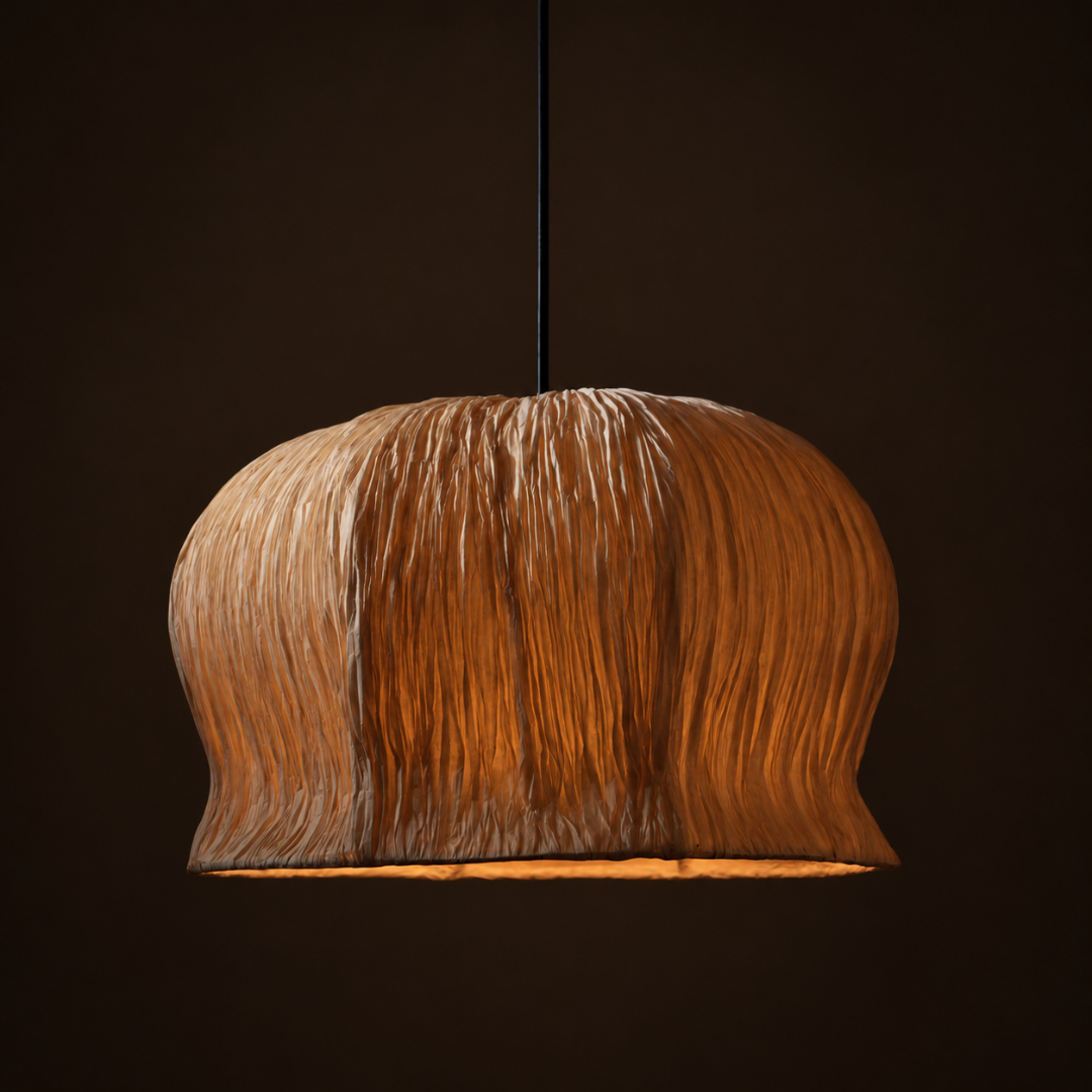 Papyrus Bellflower Pendant Lamp illuminated, showing its rounded crown and folded shade against a dark background.