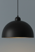 Black pendant light against a gradient gray background