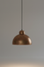 Bronze pendant light against a gray background