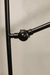 Close-up of a black metal stand on a beige background