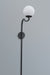 Elegant arched wall lamp featuring a black metal frame and a soft-glow white lampshade, enhancing a stylish interior.