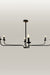 Elegant black metal chandelier with candle flame light bulbs, providing a warm glow in an entryway