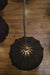 Elegant chandelier adorned with ornate glass designs, spreading soft light across a large ballroom.