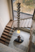 Modern staircase with a unique pendant light fixture and sculpture in a contemporary interior.