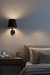 Modern bedroom with a bedside table and wall lamp.