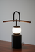 Modern table lamp with wooden arm on a wooden surface