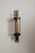 Modern wall-mounted light fixture with a metallic finish on a neutral background