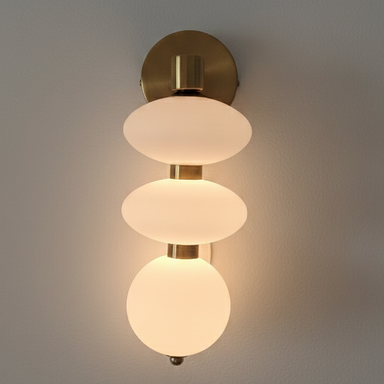Modern wall light fixture with three glass shades on a gray background