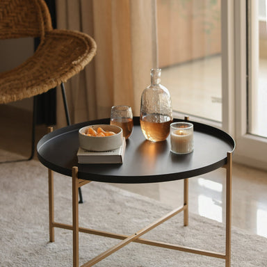 Metal side table in a living room with Black tray.