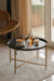 Metal side table in a living room with Black tray.