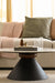 Marble coffee table with unique black pedestal base, decorated with Kinfolk book and vases.