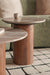 Wooden side table with marble-like top in a living room setting