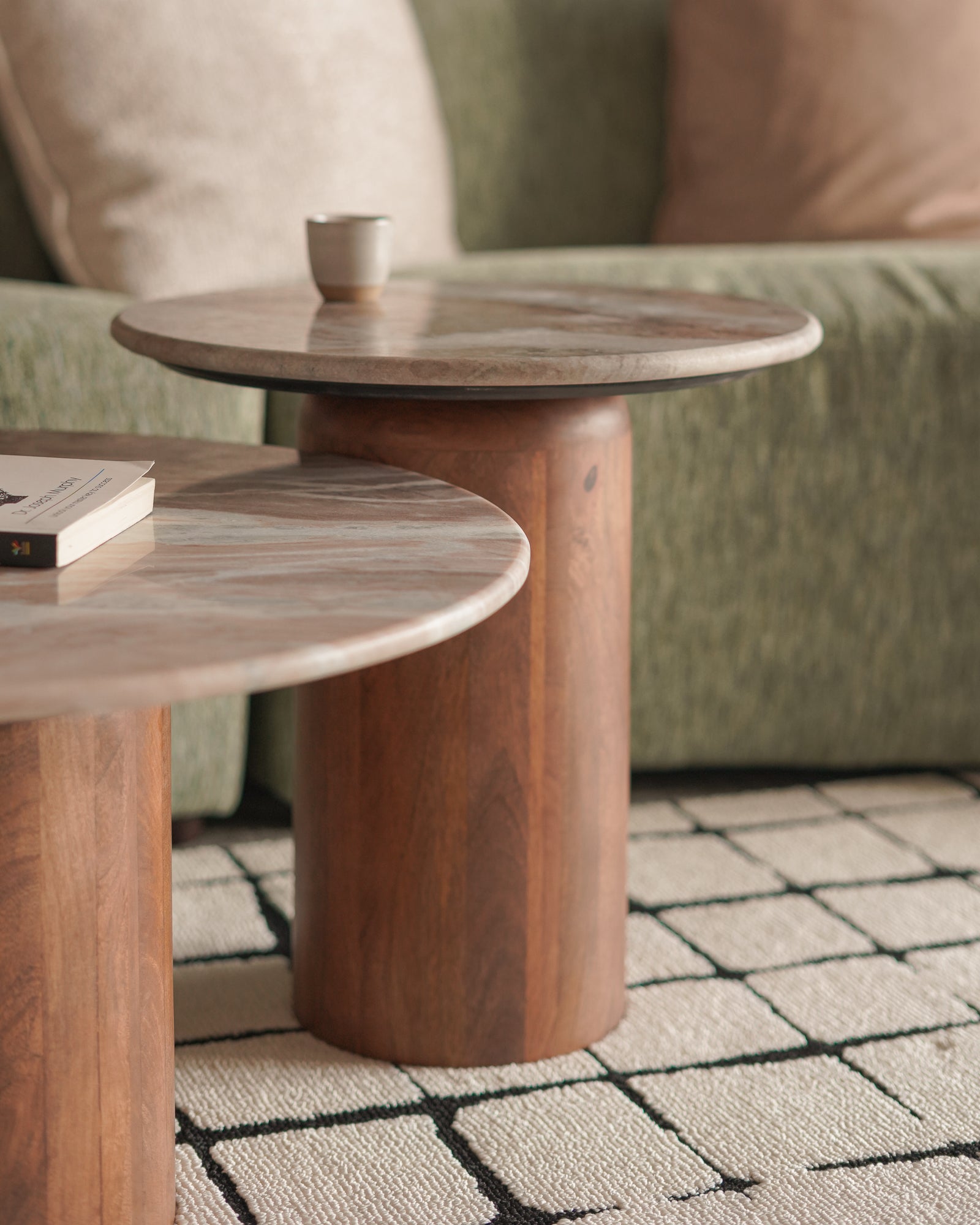 Wooden side table with marble-like top in a living room setting