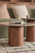 Wooden coffee table with a book on a green sofa in a living room setting