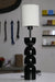 Sleek black and white table lamp with rounded segments and a modern minimalist design.