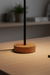 Wooden desk lamp on a wooden surface with a blurred background
