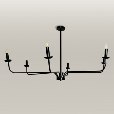 Candlelight Elegance Chandelier with sleek black metal arms and candle flame light bulbs, hanging in a modern living room.