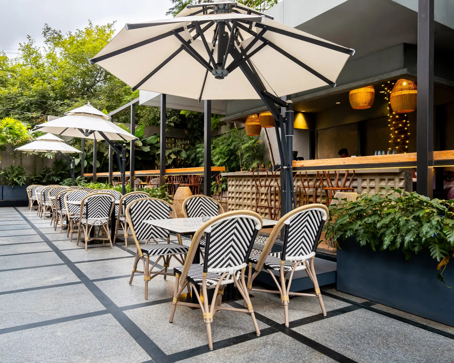 Beige and black patio umbrella with a sleek, modern frame.