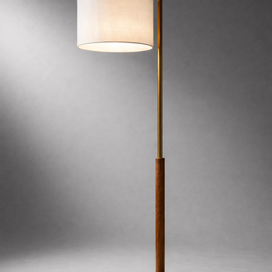 Floor lamp with a white shade and gold base on a gray background