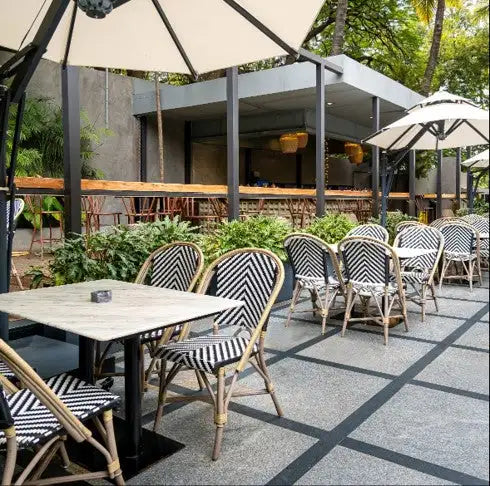 Black and white herringbone-patterned chairs with light-colored wooden frames.