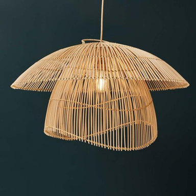 Woven rattan pendant light against a dark background