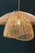 Woven rattan pendant light against a dark background