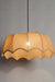 Elegant fabric pendant light suspended from a sleek black cord, perfect for dining and living spaces.