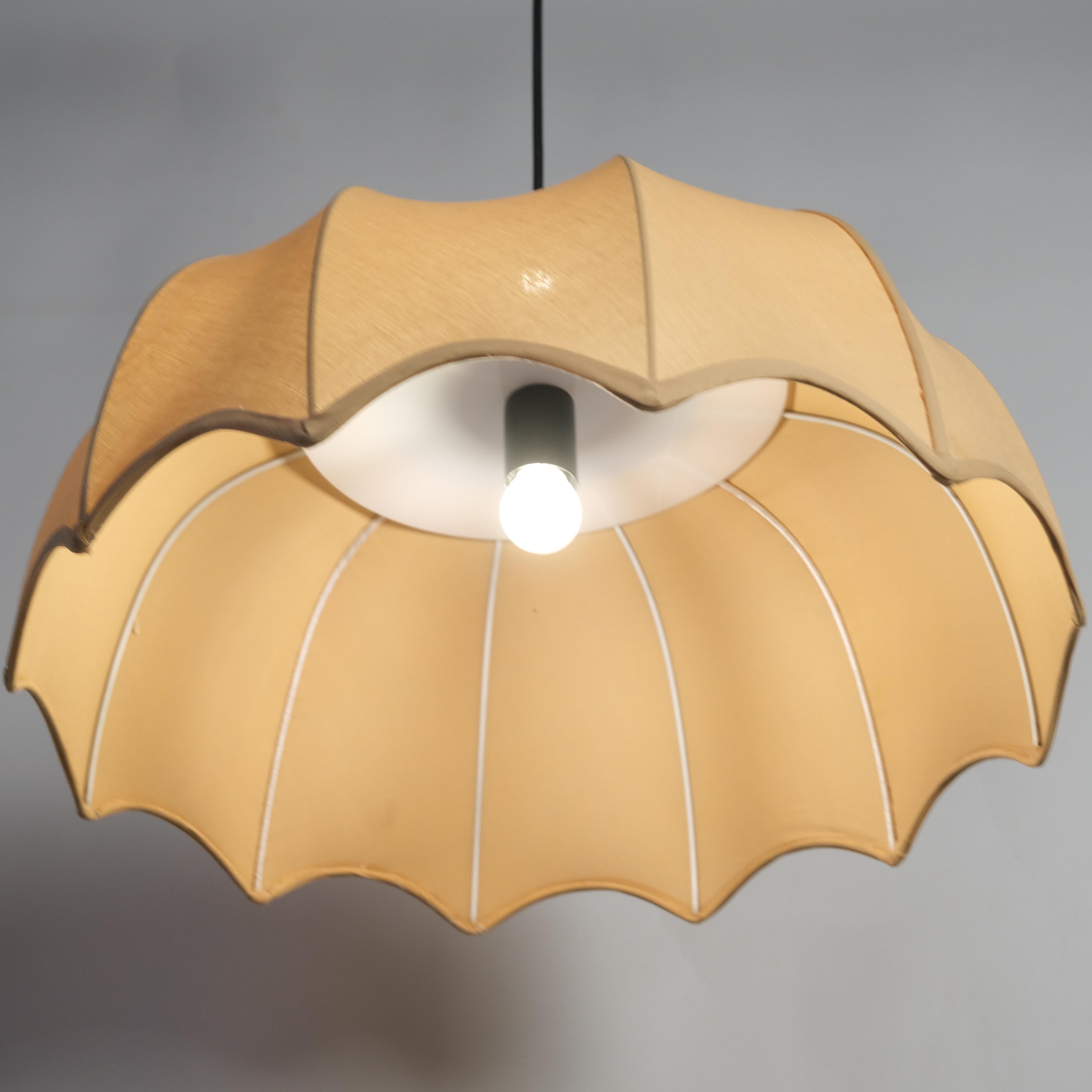 Adjustable cord fabric pendant light with a beige shade, ideal for versatile interior d√©cor needs