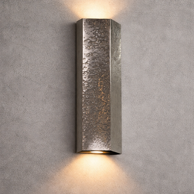 Textured wall sconce light fixture on a gray concrete wall