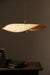 Thin wavy bamboo hanging lampshade handcrafted with elegant curved weaving, offering a warm ambient glow and a modern eco-friendly décor aesthetic.