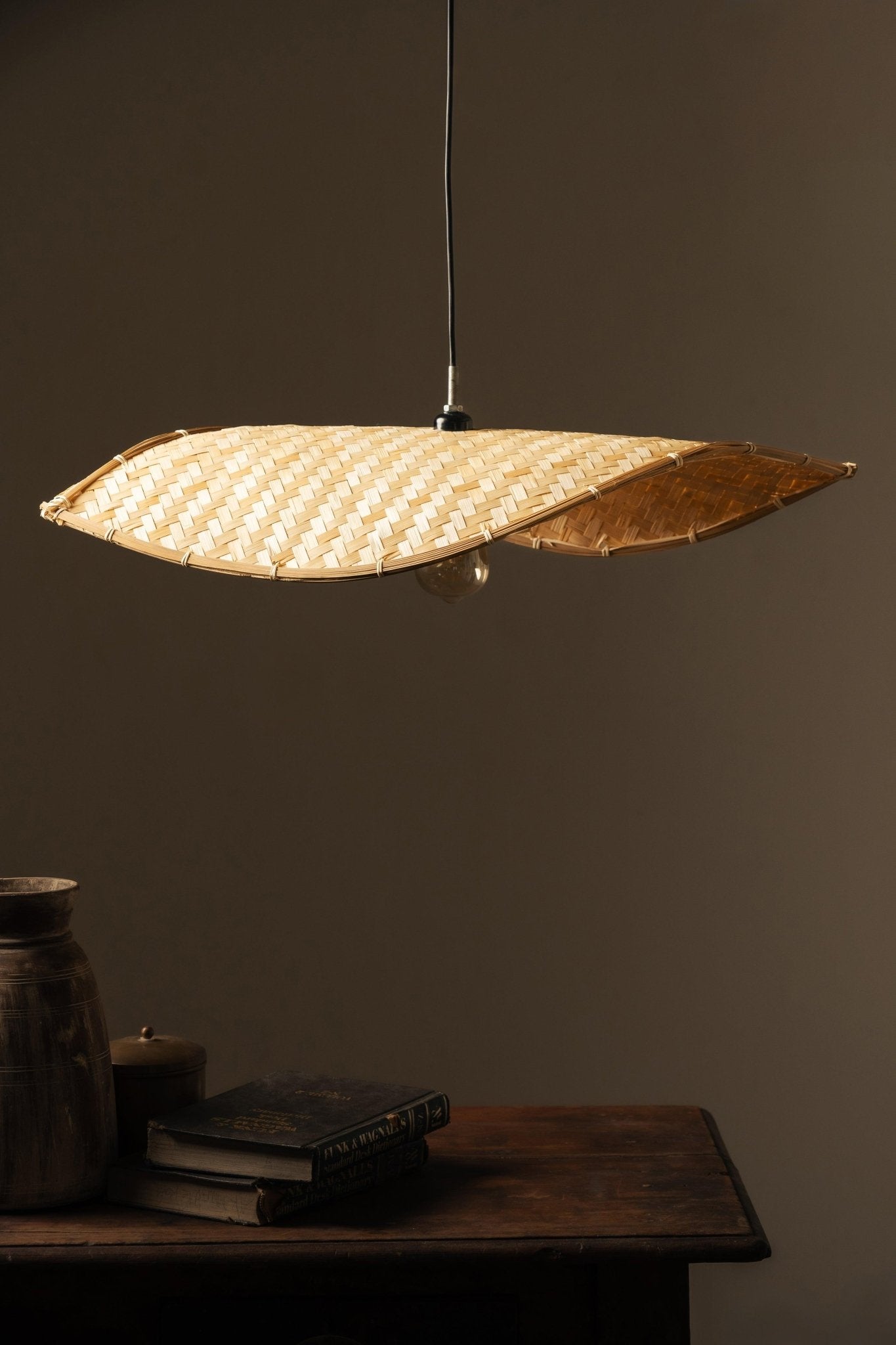 Thin wavy bamboo hanging lampshade handcrafted with elegant curved weaving, offering a warm ambient glow and a modern eco-friendly décor aesthetic.
