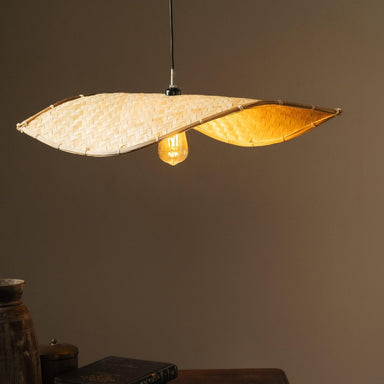 Thin wavy bamboo hanging lampshade handcrafted with elegant curved weaving, offering a warm ambient glow and a modern eco-friendly décor aesthetic.