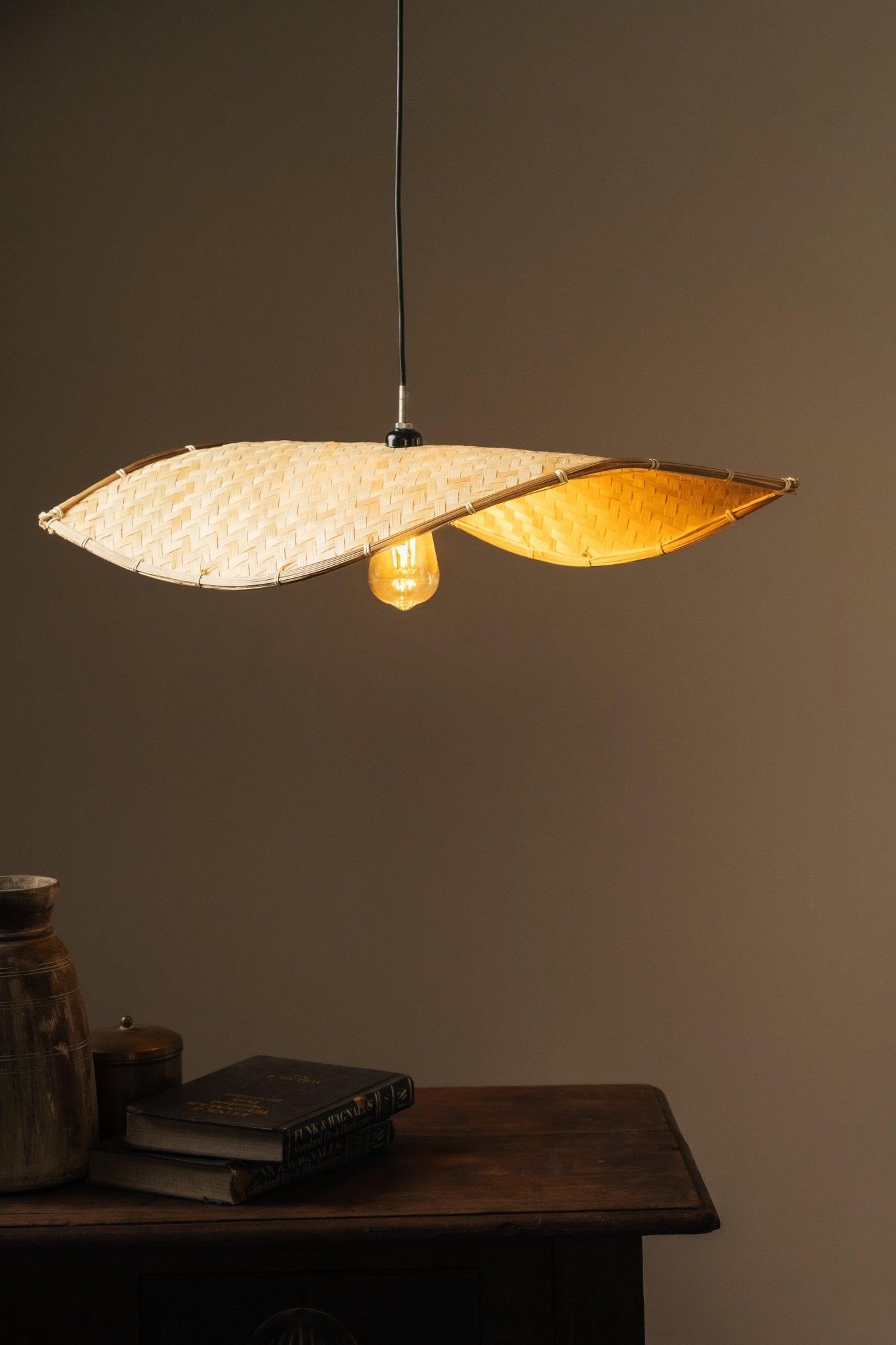 Thin wavy bamboo hanging lampshade handcrafted with elegant curved weaving, offering a warm ambient glow and a modern eco-friendly décor aesthetic.