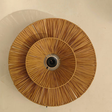 Ceiling light fixture with woven design on a beige wall