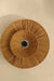 Ceiling light fixture with woven design on a beige wall