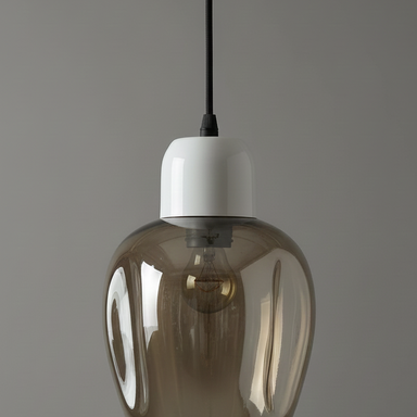 Smoked glass pendant light with white base on a gray background