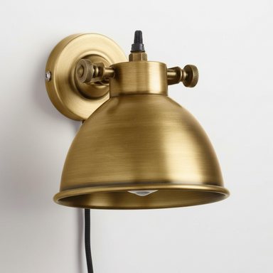 Brass wall-mounted light fixture on a white background