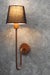 Urban Elegance Wall Lamp with a sleek black lampshade and copper-colored metal arm, mounted on a wall