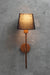 Modern industrial wall lamp featuring a minimalist black shade and elegantly curved copper arm