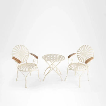 White metal patio set with wooden armrests and sunburst-patterned seats.